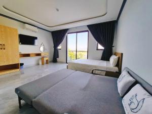 Postel nebo postele na pokoji v ubytování Phuong Linh Hotel - Ninh Thuận + 23 fotografií