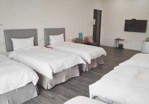 Ένα ή περισσότερα κρεβάτια σε δωμάτιο στο Happy Guesthouse