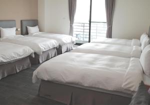 Ένα ή περισσότερα κρεβάτια σε δωμάτιο στο Happy Guesthouse