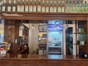 a bar with a lot of bottles of wine at Japitan Waterfront Resort in Dolores