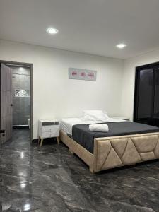 a bedroom with a large bed in a room at Quinta Emmanuel in Guaduas