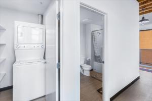 a white kitchen with a refrigerator and a toilet at Bremerton Bay Condos in Bremerton +30 photos