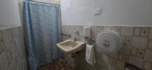 a bathroom with a sink and a shower curtain at Antique Luna in Santa Ana