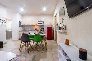 a kitchen with a table and chairs and a red refrigerator at Bello y económico departamento in Mexico City