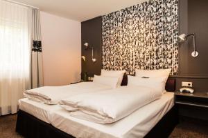 Postel nebo postele na pokoji v ubytování Best Western Hotel Nürnberg am Hauptbahnhof