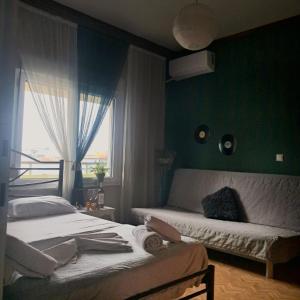 a bedroom with two beds and a window at Compass in Kavála