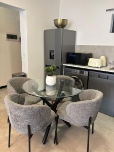 a glass table and chairs in a kitchen at Mandalay Boutique in Sandton +2 photos