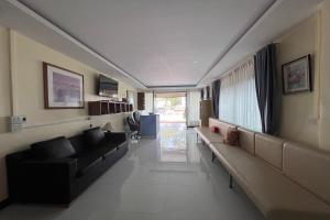 a living room with black couches at Lan Bua Resort in Phatthalung +64 photos