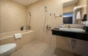 a bathroom with a shower and a sink and a toilet at A25 Hotel - 221 Bạch Mai in Hanoi +14 photos