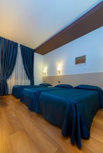 Postelja oz. postelje v sobi nastanitve Sam Hotel
