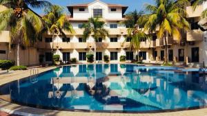 a large swimming pool in front of a building at Rompin Beach Resorts in Kuala Rompin