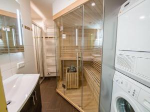 a bathroom with a shower and a washing machine at Chalet in Austria near Ski Lift & Sauna in Wald im Pinzgau +16 photos