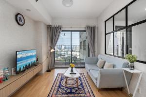 a living room with a couch and a tv at Capacious apartment 2 BRs in Masteri Thao Dien in Ho Chi Minh City