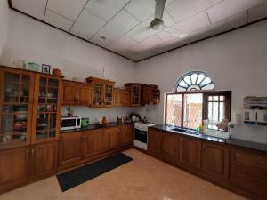a large kitchen with wooden cabinets and a window at Grace Green Ville in Negombo +67 photos