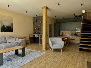 a living room with a couch and a table at Apex Panorama Hotel in Yablunytsya