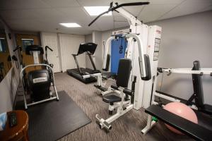 a gym with several exercise equipment in a room at Super 8 by Wyndham Whitecourt in Whitecourt +30 photos