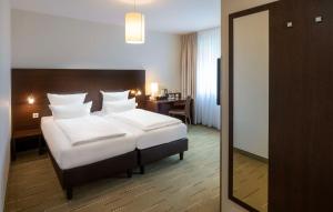 Postel nebo postele na pokoji v ubytování Best Western Hotel am Spittelmarkt