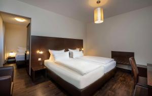 Postel nebo postele na pokoji v ubytování Best Western Hotel am Spittelmarkt