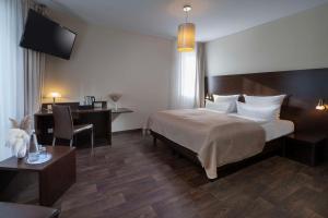 Postel nebo postele na pokoji v ubytování Best Western Hotel am Spittelmarkt