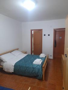a bedroom with a bed with a green comforter at ALEX's HOUSE PIZZOFERRATO in Gamberale +16 photos