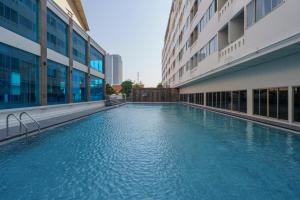 a swimming pool in the middle of a building at iCheck inn Thapra in Bangkok