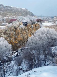 a train is traveling on a mountain in the snow at House by the River in Kʼaghsi