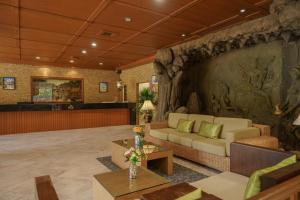 a living room with a couch and a table at iCheck inn Thapra in Bangkok