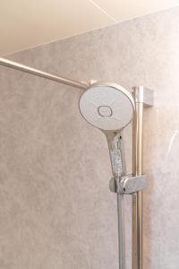 a shower head on a pole in a bathroom at RIAUS 新築一軒家貸切 最大6名 family歓迎 空港や観光地直通 in Tokyo +38 photos