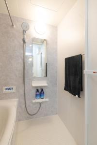a bathroom with a shower and a sink at RIAUS 新築一軒家貸切 最大6名 family歓迎 空港や観光地直通 in Tokyo