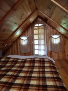 a bedroom with a bed in a attic at Holiday Home Carovina in Paradiž