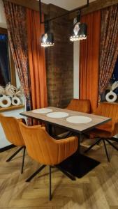 a dining room with a table and chairs at Willa Skalny Potok 605-077-100 in Zakopane
