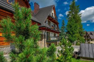 a large house with trees in front of it at Willa Skalny Potok 605-077-100 in Zakopane