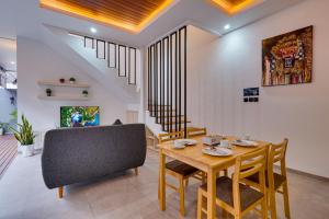 a dining room with a table and a chair at Villa Moana - Nusa Dua in Nusa Dua