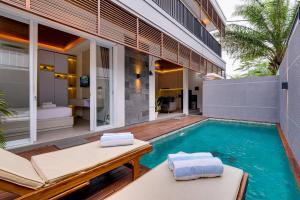 a swimming pool in the backyard of a house at Villa Moana - Nusa Dua in Nusa Dua