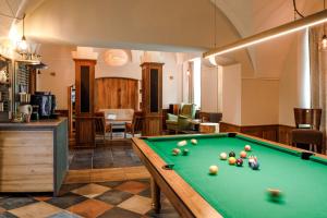 a room with a pool table in a room at Hygge Hotel U Zvonu in Vrchlabí