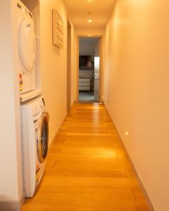 a hallway with a washer and dryer in a room at Golden Hour Villa in Queenstown