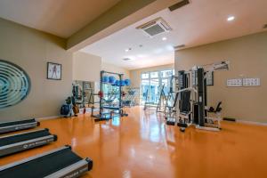 a gym with treadmills and machines in a room at Belconti Resort Hotel in Belek