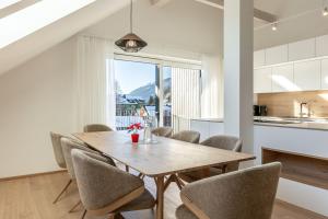 a dining room with a wooden table and chairs at Alpine Suite Spot in Bad Mitterndorf