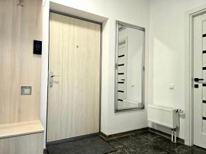 a bathroom with a door and a mirror at Spacious & Cozy Apartment in Chişinău +24 photos