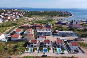 an aerial view of a village next to the ocean at Villa Stella with heated swimming pool in Privlaka