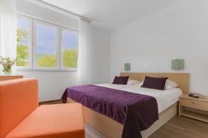 Postel nebo postele na pokoji v ubytování Hotel Slaven