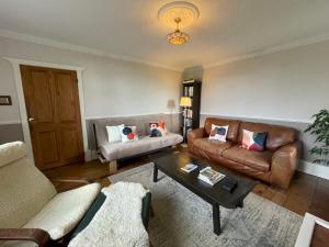 a living room with a couch and a coffee table at Idyllic Historical Country Retreat in Elkstone - Pass the Keys in Warslow