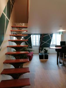 a spiral staircase in a room with a table at Bel appartement en plein centre in Lamballe