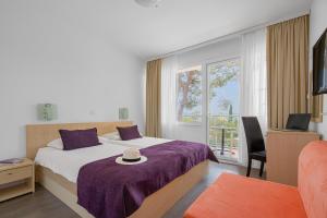 Postel nebo postele na pokoji v ubytování Hotel Slaven