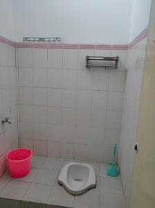 a bathroom with a toilet and a bucket at Hotel Budget Urban Space - BUS in Semarang +19 photos
