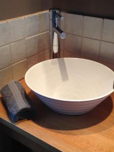 a white bowl sink sitting on a counter in a bathroom at Les Toits de Lyon au coeur du centre-ville tout à pied in Lyon +29 photos