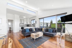 a living room with a couch and a table at Anchorage in Apollo Bay