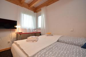 a bedroom with a bed with towels on it at Businessapart Stuttgart in Gäufelden