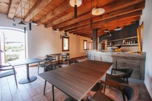 a restaurant with tables and chairs and a bar at Borgo38 in Fossalta di Portogruaro