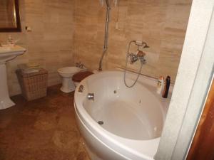 a bathroom with a bath tub and a toilet at villa il poggiale in Empoli +9 photos